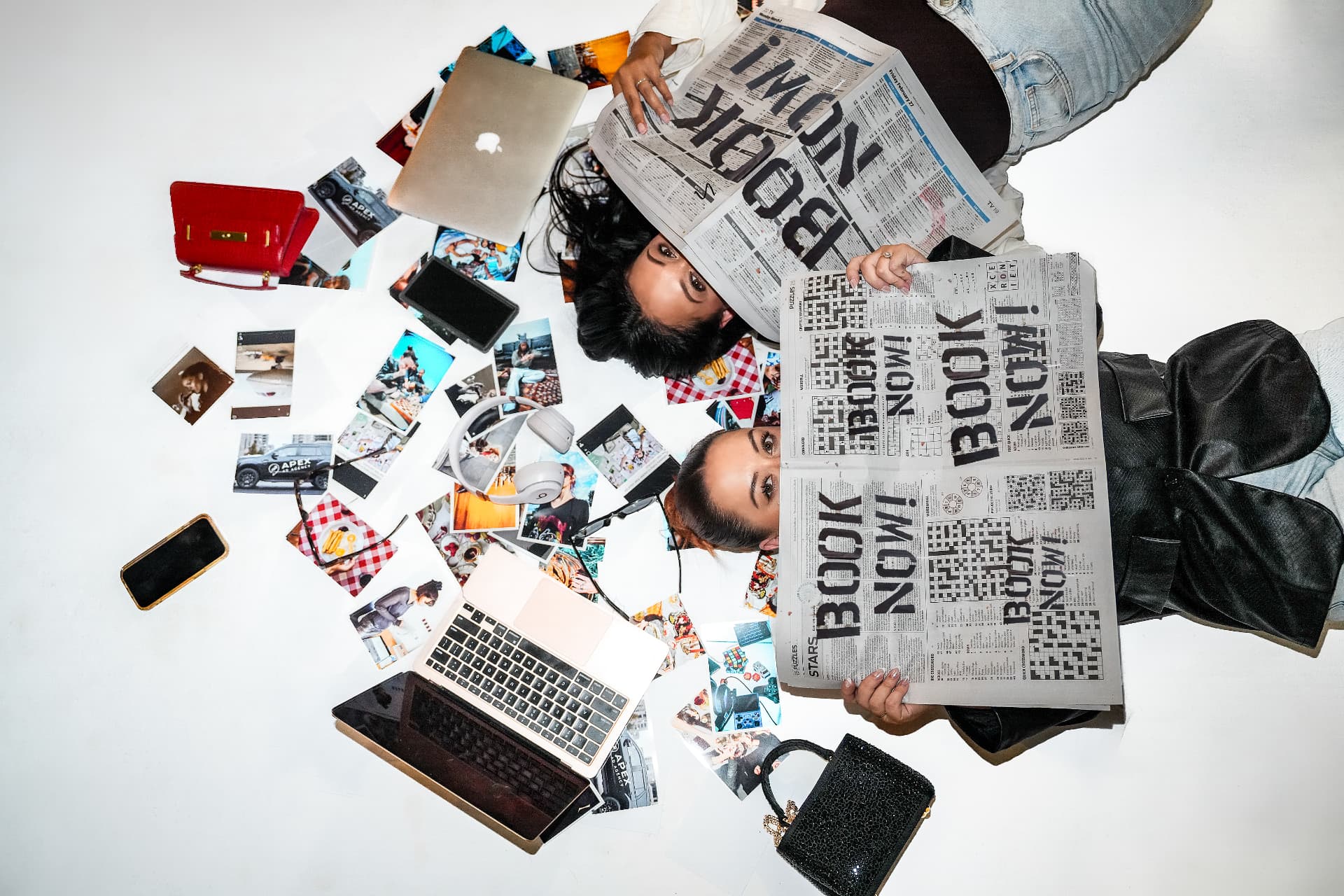 Apex team holding Book Now newspapers